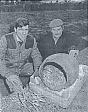 Farmer Andrew Carver, left, and his foreman, John Lester, with a Bronze Age burial urn from Alpington  © Eastern Daily Press