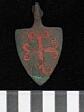 A medieval horse harness pendant decorated with red enamel found in Tacolneston.  © Norfolk Museums & Archaeology Service