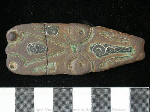 Photograph of a Middle to Late Saxon strap end with niello and silver decoration from Little Barningham.