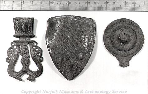 Medieval lead pilgrim badge, buckle plate and belt tag from Bircham Newton.