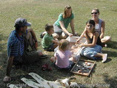 Erica Darch (NLA) and visitors using the archaeology sand pit during Archaeology Week at Gressenhall Farm and Workhouse in Summer 2006