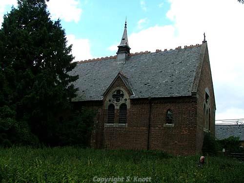 Photograph of the Holy Trinity Church, Nordelph. A Victorian red brick church, built in 1865 in the Early English style with lancet windows and plate tracery. Photograph from www.norfolkchurches.co.uk