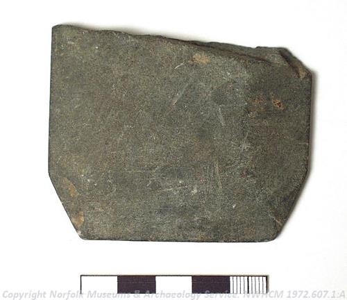 Photograph of part of a Roman slate cosmetic palette found in Caister-on-Sea. Photograph from MODES.