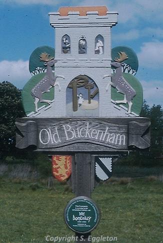 Photograph of Old Buckenham village sign by Steve Eggleton. The sign depicts Old Buckenham Castle.