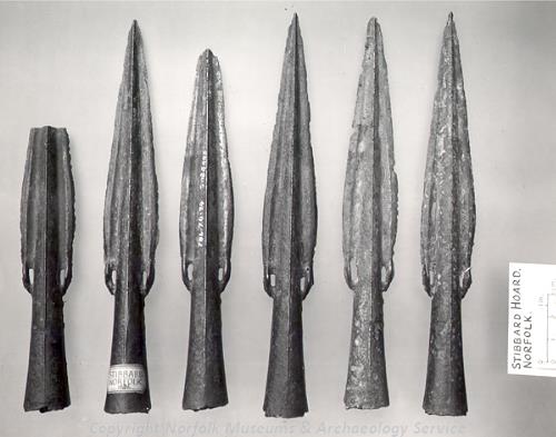 Photographs of spearheads from a Bronze Age hoard found at Stibbard.